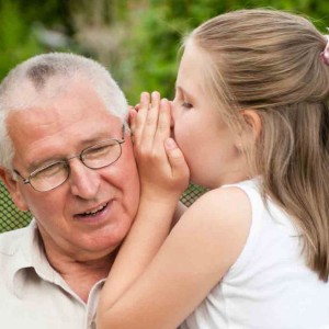 Kid Whispering to grandpa Small